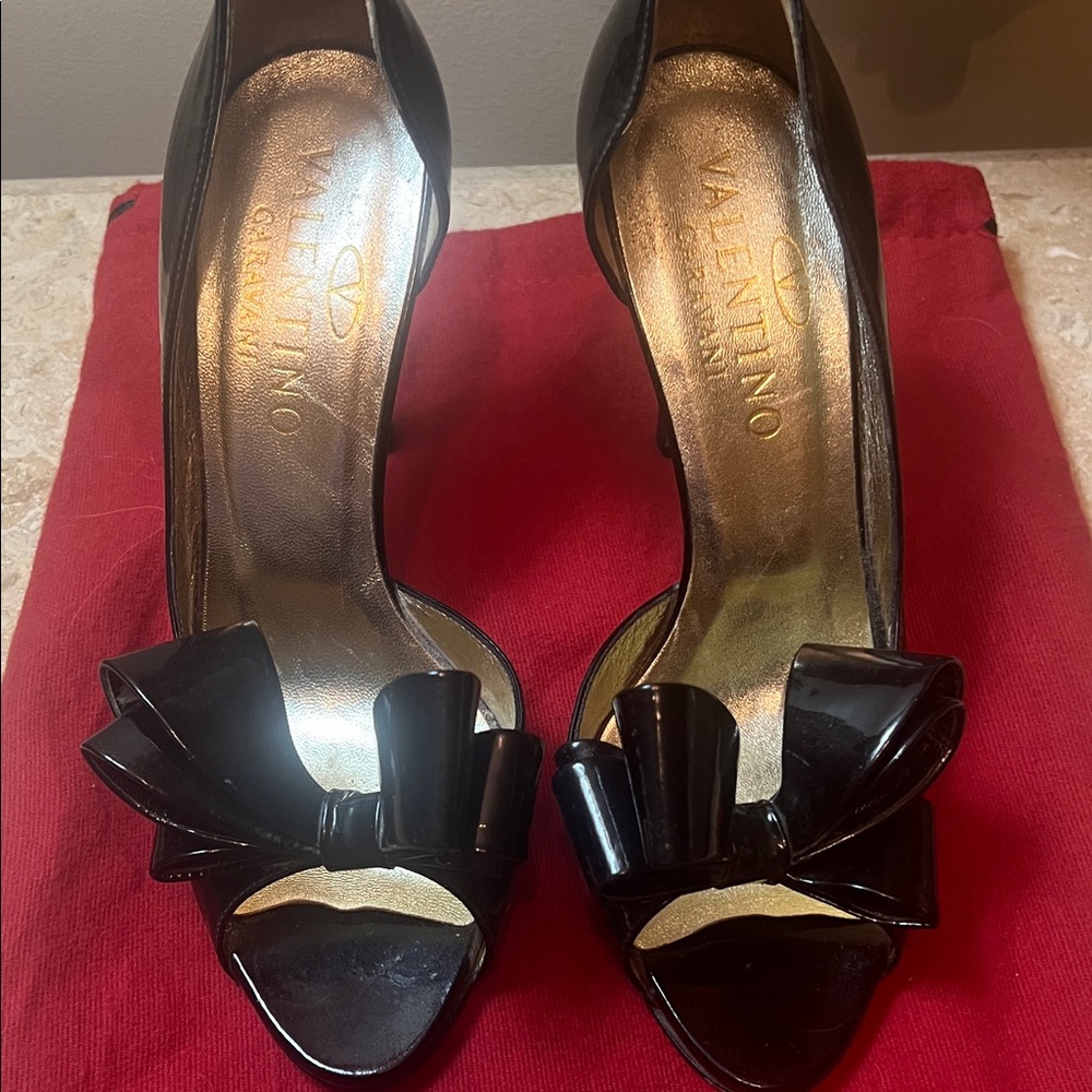 Valentino Garavani black patent pump with exaggerated bow detail.